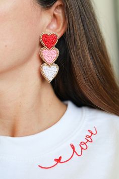 Our BEST SELLER Three Valentines Heart Earrings is back! We just restocked on 1/23 and we are ready to ship them. Hand embroidered 3 tiered heart earrings in white, pink and red with matte gold beads. Perfect shape and size! Very unique and made exclusively for Gaby & Grace customers. Very Lightweight. Lead and Nickel Free. White Heart Beads Earrings For Valentine's Day, White Heart Earrings With Beads For Valentine's Day, Valentine's Day Heart Earrings With Heart Beads, Pink And Red Earrings, Valentine's Day Heart Bead Earrings, Valentine's Day White Beaded Earrings, Valentine's Day Gift Beaded Heart Earrings, Valentine's Day Heart Beaded Round Earrings, Heart-shaped Beaded Earrings For Valentine's Day