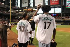 the baseball players are walking on the field