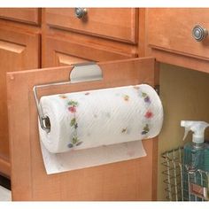 a roll of toilet paper hanging from a cabinet