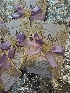 purple and gold wedding cards with bows on sequins