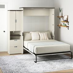 a white bed sitting next to a wooden dresser on top of a rug in a bedroom