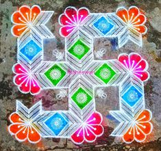 an intricately designed rangdi work on the ground with colorful flowers and leaves in it