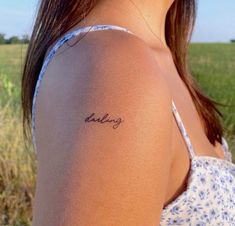 a woman with a tattoo on her arm that says, believing in cursive writing