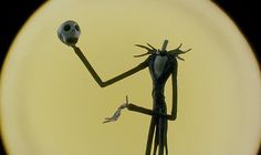 a cartoon character holding a skull in one hand and a ball in the other with both hands