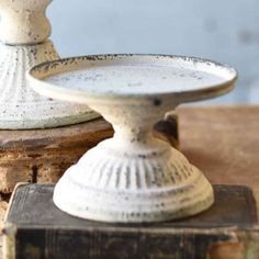 two white dishes sitting on top of an old book