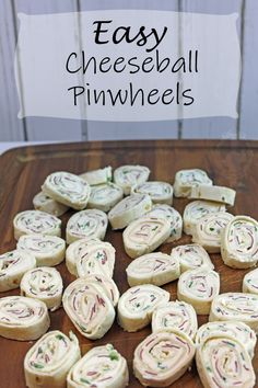 easy cheeseball pinwheels on a cutting board with text overlay that reads easy cheeseball pinwheels