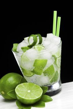 limes and ice in a glass on a table