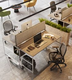 an office cubicle with chairs, desks and laptop computer on it's side