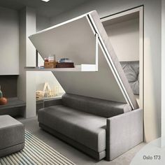 a living room with a couch, ottoman and book shelf in the shape of an upside down window