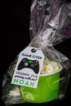 a plastic bag filled with food and a game controller sticker on top of it