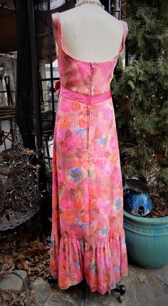 "Lovely Bright 1960's Silk Floral Homemade Sleeveless Pink Full Length Dress XXS This is a stunning vintage pink floral full length dress. I believe the fabric here is silk. It's extremely light weight and airy. There is a full lining here in pink and a long back zipper. It's a swoop neckline with an Empire Waistline with a lovely pink bow at the front. The bottom 11\" of the dress is a ruffle. I see no condition issues here at all. The dress is in amazing condition. It is however quite small so Retro Sleeveless Spring Party Dress, Retro Sleeveless Party Maxi Dress, Pink Fitted Retro Maxi Dress, Retro Sleeveless Dress For Spring Party, Retro Sleeveless Maxi Dress For Party, Retro Fitted Pink Maxi Dress, Vintage Sleeveless Maxi Dress For Garden Party, Retro Sleeveless Vintage Dress For Garden Party, Retro Sleeveless Lined Dress