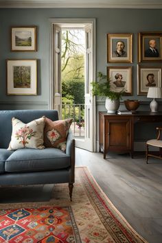 a living room filled with furniture and pictures on the wall