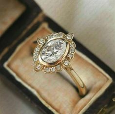 an engagement ring in a box with diamonds