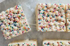 four pieces of cake with sprinkles and white frosting