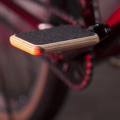 a close up of a skateboard attached to a bike