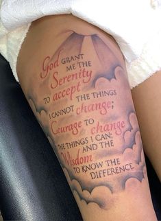 a woman's arm with an umbrella and bible verse tattoo on the left leg