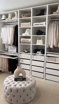 a walk in closet filled with lots of white drawers and shelves full of clothing items