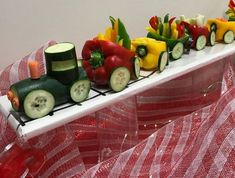 a train made out of cucumbers, peppers, and other veggies