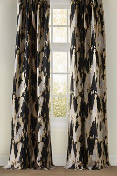 the curtain is open and ready to be hung in front of a window with an abstract pattern