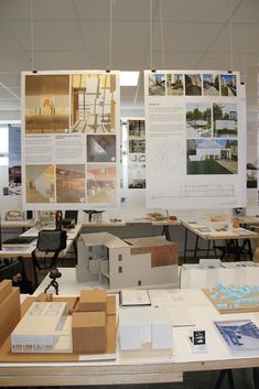 an office area with desks, chairs and pictures on the wall