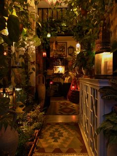 the hallway is decorated with plants and candles