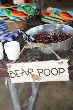 there is a sign that says bear poop next to some food on the table