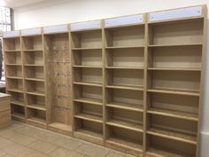 empty wooden shelves in a room with tile flooring