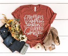 a t - shirt that says eat pray give thanks with the words, and some fall leaves