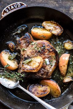 a skillet with some meat and potatoes in it