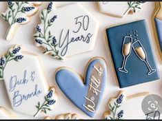 decorated cookies with the words 50 years and two glasses of champagne on them are arranged next to each other