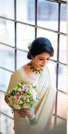 a woman in a white dress holding a bouquet