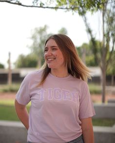 Don't be fooled by the claws that we got, still the nicest Tigers on the Block! Represent the best college mascot wherever you geaux with our Comfort Colors Tiger Block t-shirt available in three colors: Orchid, Butter, & Heather Grey. 100% Pre-Shrunk CottonUnisexOrchid Sizing: S M L XL 2X 2/4 6/8 10/12 14/16 16/18 Collegiate Pre-shrunk T-shirt For Campus, Sporty College Mascot T-shirt, Collegiate Cotton T-shirt With Mascot, Purple T-shirt With Team Name For Campus Wear, Collegiate Short Sleeve T-shirt With Mascot, Collegiate Crew Neck T-shirt With Mascot, Collegiate Style Screen Printed Tops, Collegiate Screen Print Top For Campus, Collegiate Style Screen Print Tops For Campus