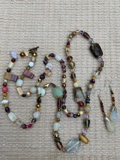 a variety of beads and necklaces laid out on a table