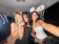 three women in bunny ears are posing for the camera