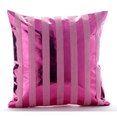 a pink and black striped pillow on a white background