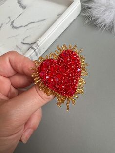 This bead embroidery heart  brooch is made with high quality gold and red  beads. Each bead is sewn by hand. The heart is surrounded by the  red ball chain. The heart is made with red felt and beads. ☀ All orders are specially wrapped and are ready to give as a gift ☀ Welcome to my shop! ☀Handmade earrings, brooches, headbands, other minimalist accessories - this is my world, world of EkkosKs.☀ All my work becomes from my inspiration - that's why in my shop you can see only unique and special je Heart Embroidery Patterns, Seed Bead Heart, This Is My World, Red Brooch, Embroider Ideas, Embroidery Heart, Bead Heart, Embroidery Hearts, Beaded Heart