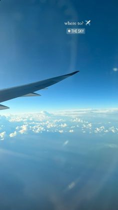 the wing of an airplane flying over clouds