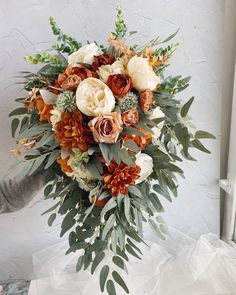 a bridal bouquet with orange and white flowers