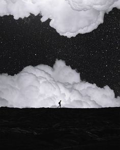 a man standing on top of a hill under a night sky filled with stars and clouds