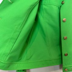 St. John Sport by Marie Gray Green Jacket. Has light shoulder pads. Gold details throughout including logo buttons. Bright green colored lightweight jacket. Collared jacket with button down front. Rivets on the collar and bottom hem. This item have been hemmed at the cuff, however the hem can be let out and returned back to its original cuff length, as shown in photos. Made in the USA Women's size Small Petite Measurements with the garment laying flat: Pit to pit: about 19 inches Length: about 2 Green Spring Outerwear With Buttoned Pockets, Green Outerwear With Buttoned Pockets For Spring, Trendy Green Outerwear With Buttons, Green Buttoned Pockets Outerwear For Work, Classic Green Outerwear With Buttoned Pockets, Green Spring Outerwear With Buttons, Green Outerwear With Buttoned Pockets For Work, Classic Green Outerwear With Button Cuffs, Green Single Breasted Cotton Outerwear