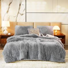 a bedroom with a large bed covered in grey fur