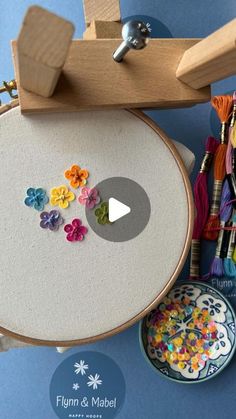 a video demonstrating how to make an embroidery kit with flowers and beads on the hoop