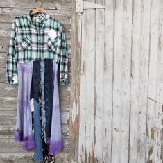 an old shirt hanging on a wooden wall