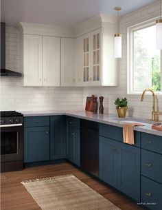 a kitchen with blue cabinets and white tile backsplash, wood flooring and an area rug