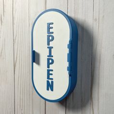 a blue and white sign hanging on the side of a wooden wall that says epippenn