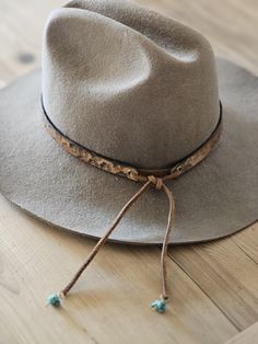 add instant cool to your favorite  felt or cowboy hat! I hand make every hat band to order using top grade leather. 1/2" inch wide hand tooled floral pattern antique brass eyelets stained light brown/ beige  antique one size fits all ( 55 to 66 cm) with adjustable strong suede strap hand beaded turquoise stone ends Personalization: I will stamp your 2 initials beside the antique gold eyelet using my 1/4'' inch uppercase alphabet font just write them in the personalization box at checkout All lea Felt Hat Band, Cowboy Hat Bands, Hat Bar, Beaded Hat Bands, Uppercase Alphabet, Hat Bands, Alphabet Font, Beaded Hat, Western Hat