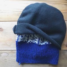 a blue and white hat sitting on top of a wooden floor