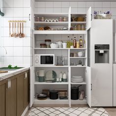 a kitchen with white cabinets and shelves filled with dishes, utensils and other items