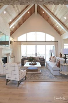 a living room with couches, chairs and a fire place in the middle of it