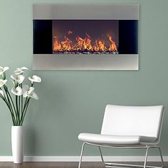 a white chair sitting in front of a wall mounted fire place